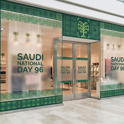 Saudi National Day 96 shop window branding with flags on a storefront in Riyadh — Admark Prints National Day storefront windo